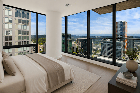 A bedroom with a large bed and a view of the city.