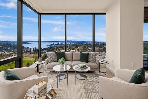 A living room with a view of the city and water.