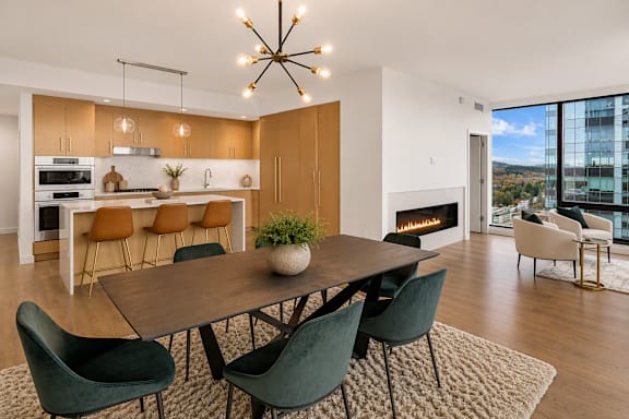 A modern dining room with a wooden table and chairs.