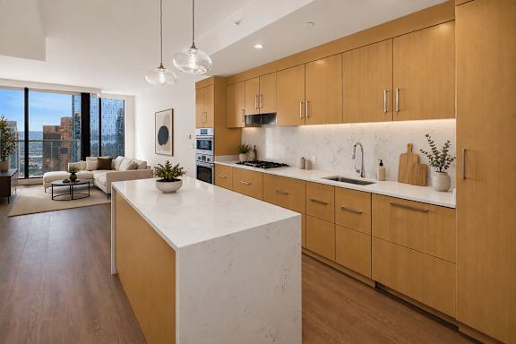 A modern kitchen with wooden cabinets and a white island.