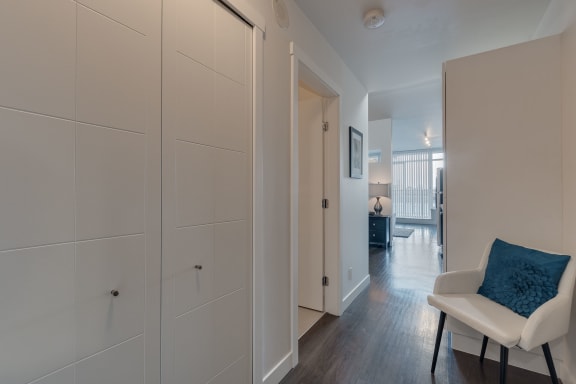 a bedroom with a bed and a chair in a room