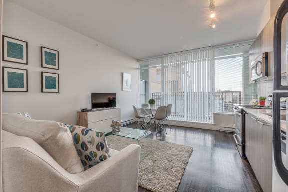 a living room with hardwood floors and white walls