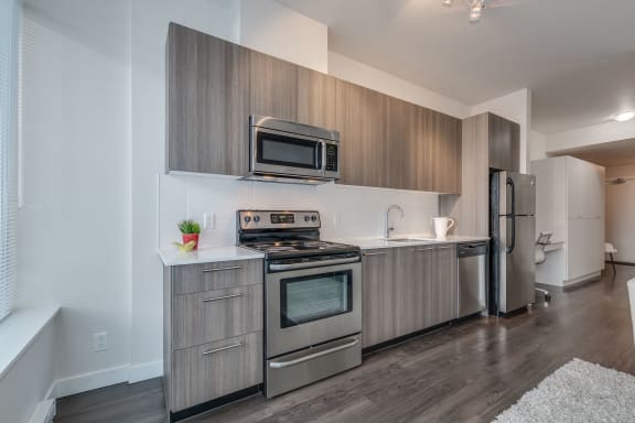 a kitchen with stainless steel appliances and wooden cabinets