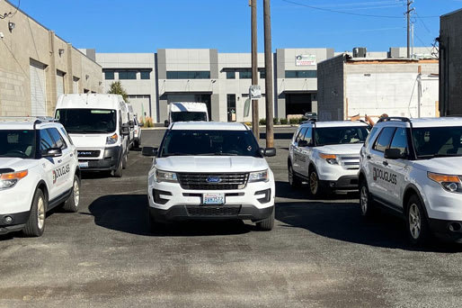 A row of white police SUVs are parked in a lot at Graymayre Crossing Apartments, Spokane, WA, 99208