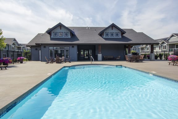 a large swimming pool in front of a building at The Brix Apartments, Spokane Valley, WA, 99037