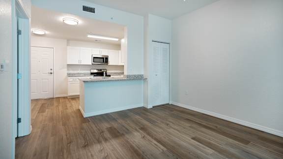 A kitchen with a microwave and oven built into the countertop.