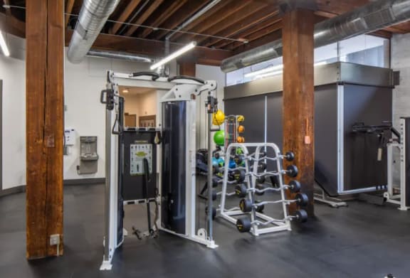 the interior of a gym with weights and a boiler