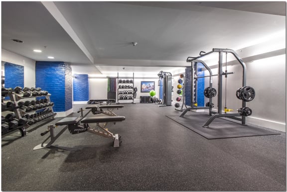 a spacious fitness center with weights machines and other workout equipment
