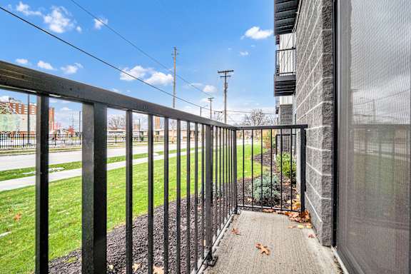 A black metal fence leads to a building entrance. at Park Lamont Townhomes Apartments, Cleveland 44106