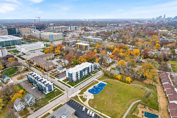 A view of a city from a high vantage point with buildings, trees, and a pool. at Park Lamont Townhomes Apartments, Cleveland, Ohio