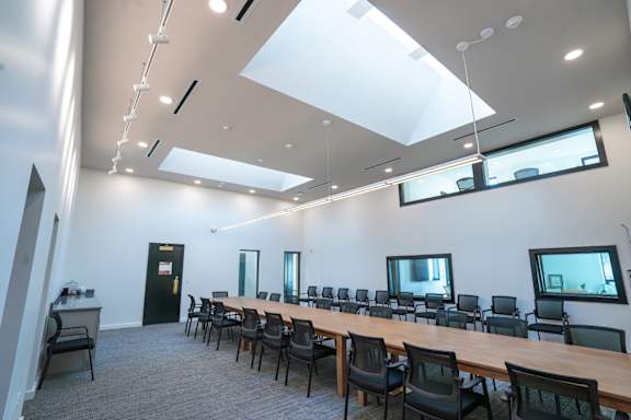 A conference room with a long table and chairs at Life At Agora Apartments, Cleveland, Ohio