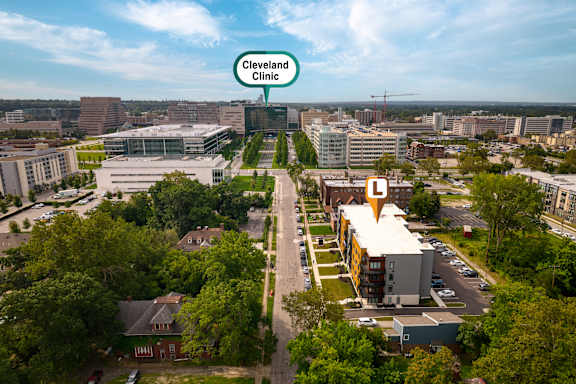 An aerial view of a city with a building labeled Cleveland Clinic. at The Lumos Apartments, Cleveland, OH