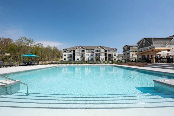 a swimming pool with apartments in the background at The Bend, Lancaster