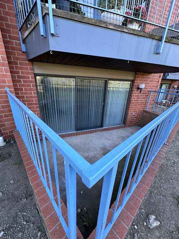 A blue metal railing on a brick building.