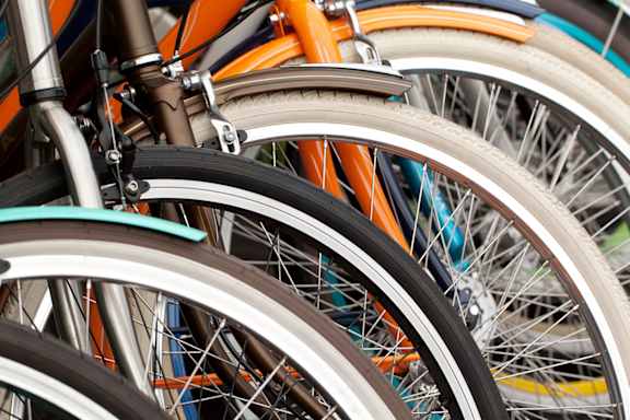 A close up of a bicycle wheel with a brown rim and a silver spokes at Life At Agora Apartments, Cleveland