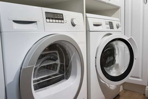 Two front loading washing machines in a laundry room at Life At Agora Apartments, Cleveland 44103
