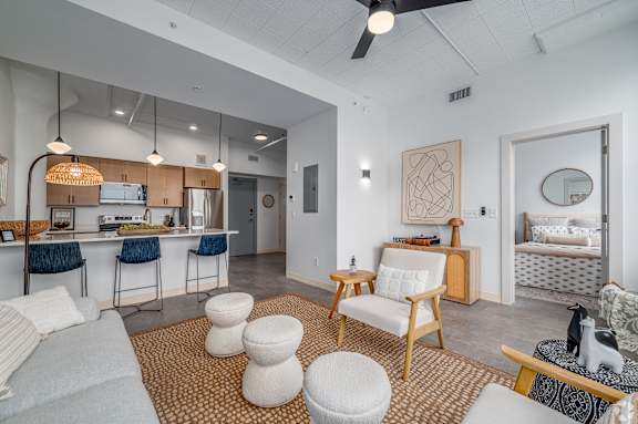 A modern kitchen with a dining table and chairs. at Life At Agora Apartments, Cleveland 44103