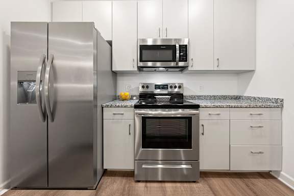 A modern kitchen with a stainless steel refrigerator and oven. at The Lumos Apartments, Cleveland