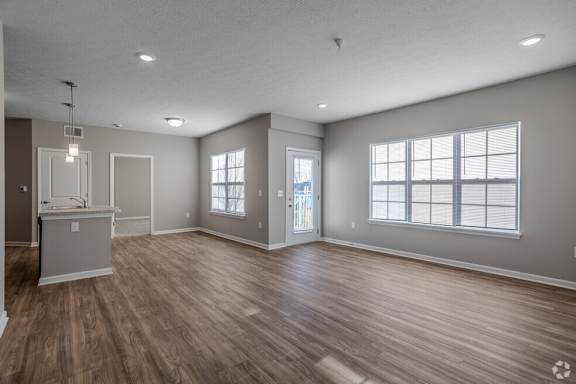 A spacious room with wooden flooring and a kitchenette.at The Residences at Akita Lane, Ohio