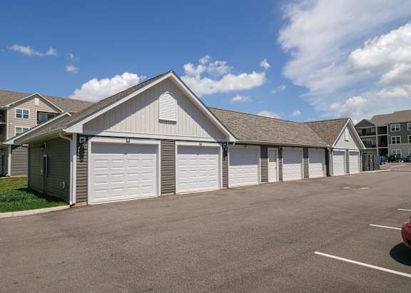 a building with white garage doors in front of an empty parking lot at The Bend, Ohio, 43130
