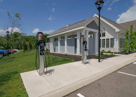 a gas station with two pumps in front of a house at The Bend, Lancaster, OH, 43130