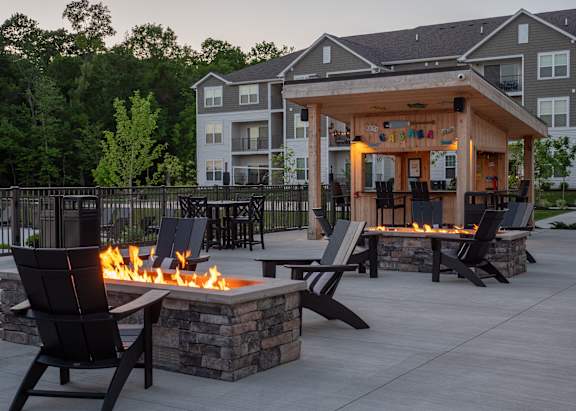 an outdoor entertaining area with a fire pit and patio furniture at The Bend, Lancaster