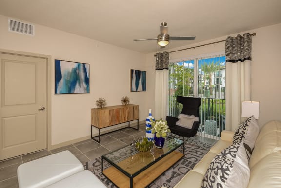 a living room with a sliding glass door leading to a balcony at Azura, Miami, Florida