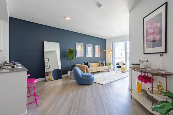 a living room with a blue accent wall and hardwood floors at Chandler Apartments in North Hollywood, North Hollywood, CA, 91601