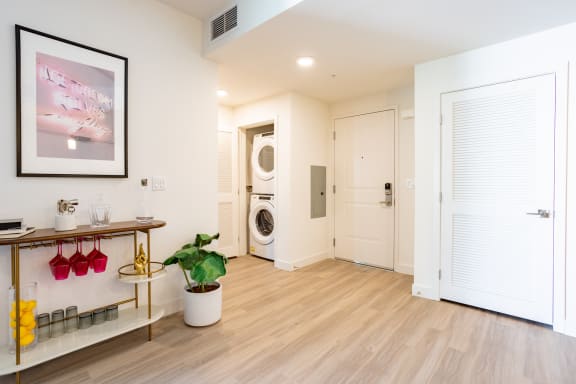 a living room with a white door and hardwood floors at Chandler Apartments in North Hollywood, North Hollywood, 91601