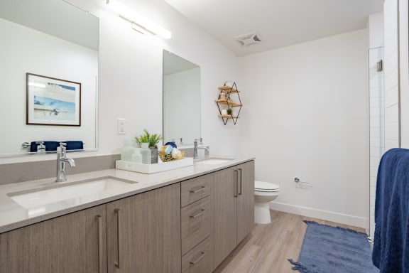 a bathroom with white walls and wood flooring at Chandler Apartments in North Hollywood, North Hollywood, CA, California, 91601