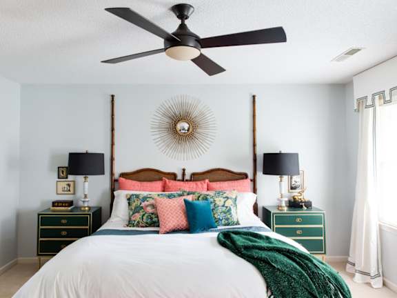 a bedroom with a bed and two night stands with lamps on them