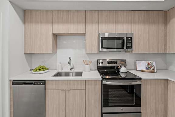 A Kitchen with Stainless Steel Appliances at The Palmeri Residences, Naples, Florida