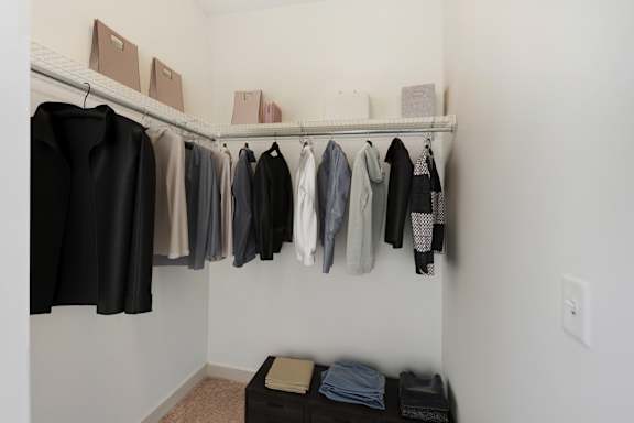 A row of clothes hanging on a rack. at The Merc, Massachusetts, 02453