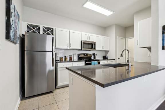 A Kitchen with a Stainless Steel Refrigerator at Flats on Chapel Apartments, Texas, 76712