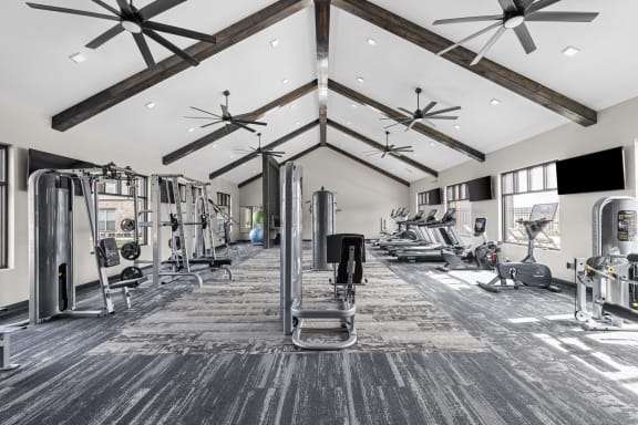 a fitness center with weights and cardio machines at Apex apartments in Colorado Springs