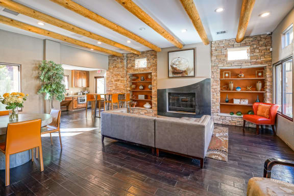 a living room with a fireplace and a table and chairs