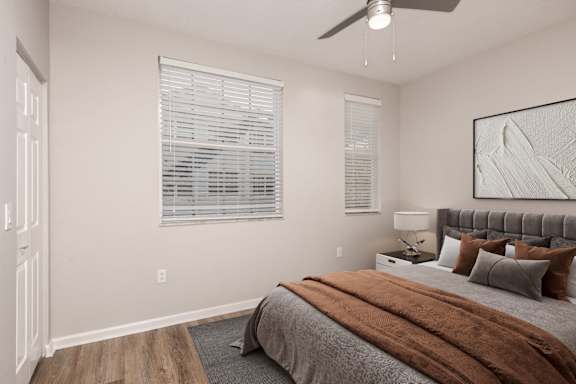 A bedroom with a bed, pillows, and a ceiling fan at Floresta, Jupiter, 33458