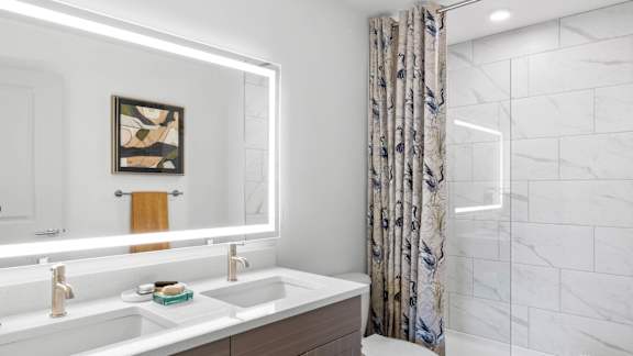 A bathroom with a white sink and a mirror.