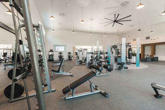 fitness center with a smith machine and free weights at Monterey Ranch, Austin, TX