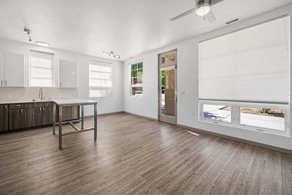 A room with a table and a window overlooking a street.