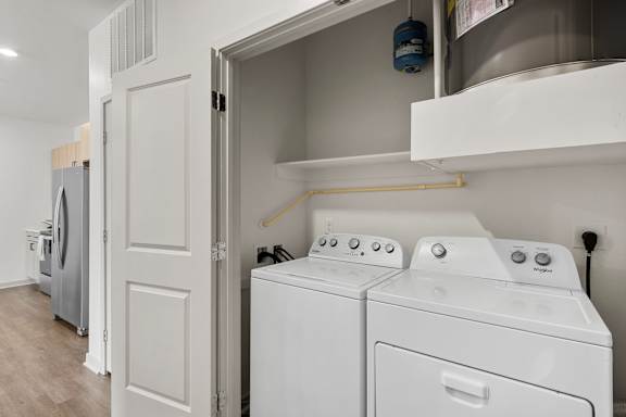 A white washing machine and dryer in a laundry room.
