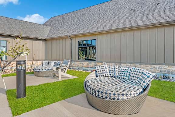 A patio with a couch and a table.