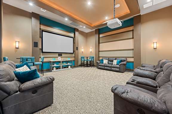 A home theater with a large screen and comfortable seating.