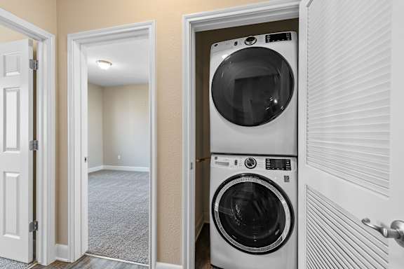 A white washing machine is in a doorway.