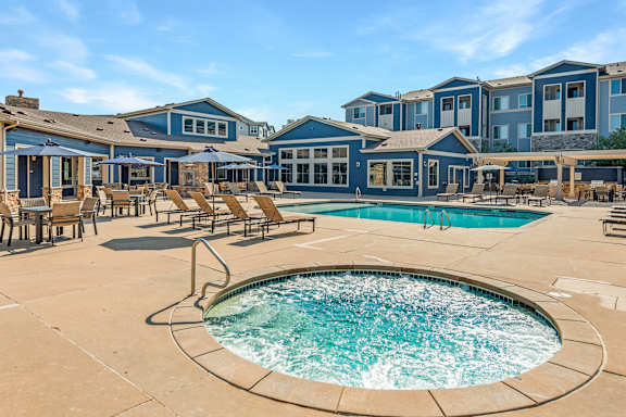 A large outdoor swimming pool surrounded by lounge chairs.