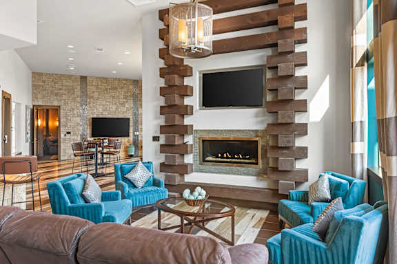 A modern living room with a fireplace and a television mounted above it.