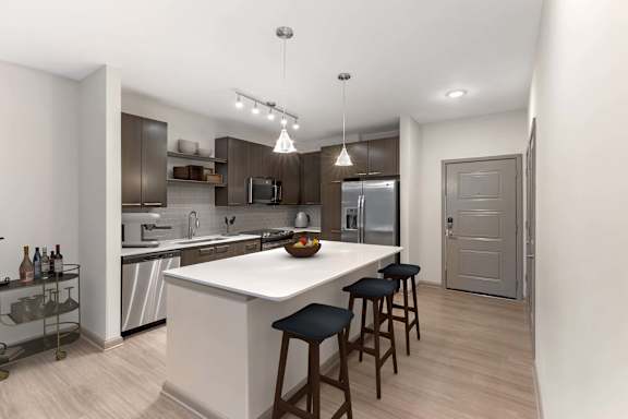 A modern kitchen with a white island at Glenwood at Grant Park, Atlanta, Georgia