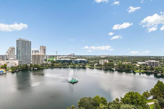 a city with a sailboat in the middle of a lake at Paramount on Lake Eola, Orlando, FL, 32801
