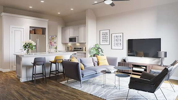 A modern living room with a bar area and a grey sofa.