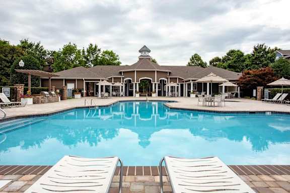 A pool with a building in the background.